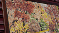 Intricate mosaic artwork featuring vibrant autumn trees in shades of orange, yellow, and green — capturing nature's beauty.