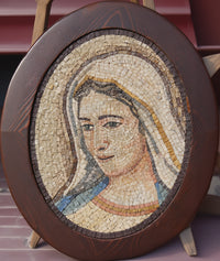 Intricate mosaic wall art featuring a serene portrait of a woman framed in dark wood — crafted with delicate stone tiles.