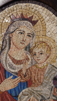 Intricate mosaic artwork depicting a mother and child, featuring vibrant colors and detailed craftsmanship in natural stone.