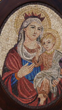 Intricate mosaic art depicting a mother and child in warm earth tones — featuring detailed craftsmanship and vibrant textures.