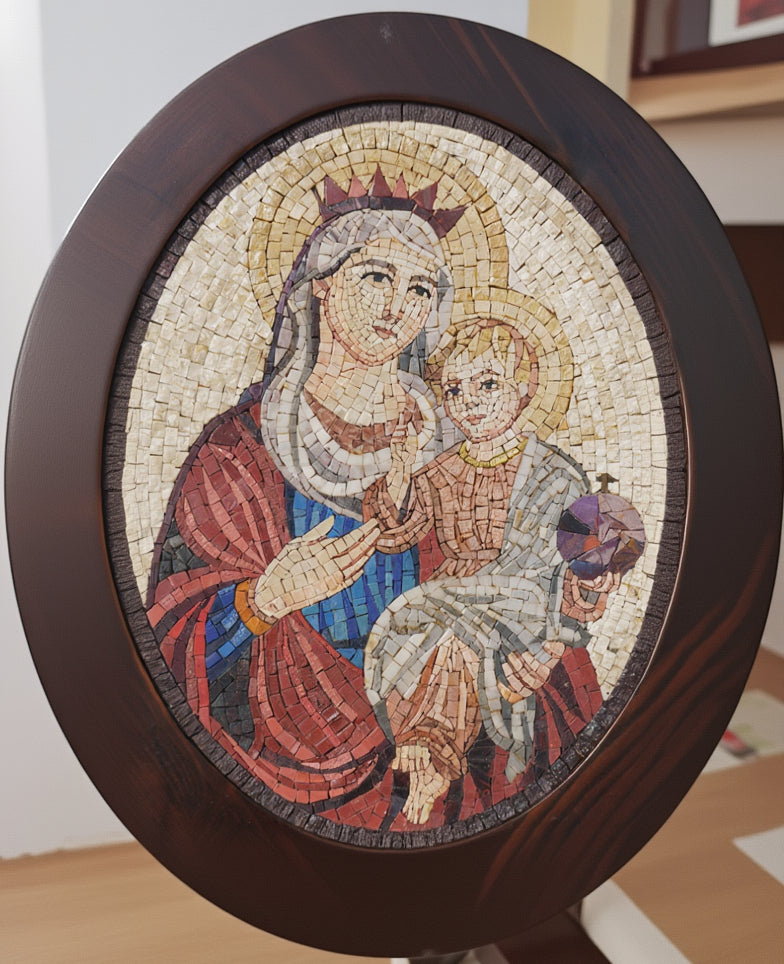 Intricate mosaic artwork depicting the Virgin Mary holding a child, framed in an elegant dark wood oval frame.