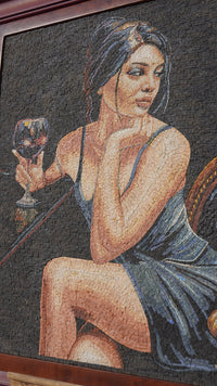 Intricate mosaic artwork featuring a woman in a blue dress holding a wine glass, showcasing detailed textures and colors.