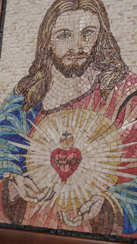 Intricate mosaic artwork depicting a figure with long hair and a radiant heart — vibrant tiles in shades of blue and gold