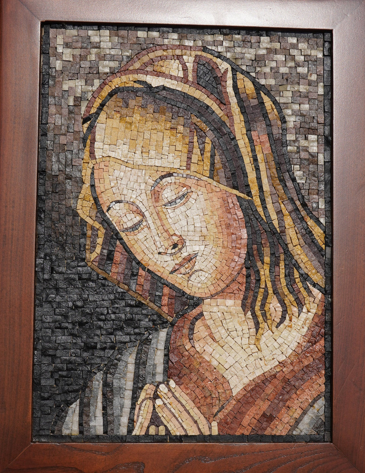 Intricate mosaic art depicting a serene figure with delicate facial features and warm earthy tones framed in rich wood.