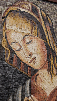 Intricate mosaic artwork depicting a serene woman with closed eyes, showcasing rich earth tones and textured tiles.