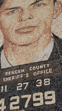 Detailed mosaic artwork depicting a sheriff's badge with a historical portrait and textured stone finish