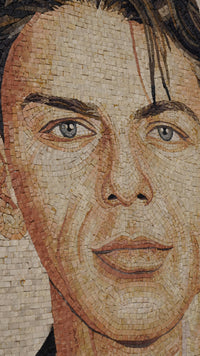 Intricate mosaic portrait featuring a young man with expressive blue eyes and detailed textured stone tiles.