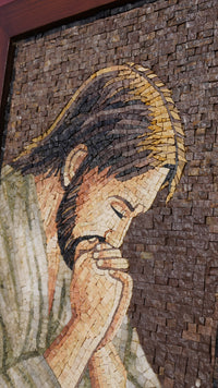Intricate mosaic artwork depicting a contemplative figure with detailed stone textures and warm earthy tones.