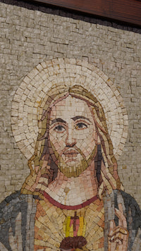 Intricate mosaic artwork depicting a serene figure with a golden halo, crafted from various natural stone tiles.