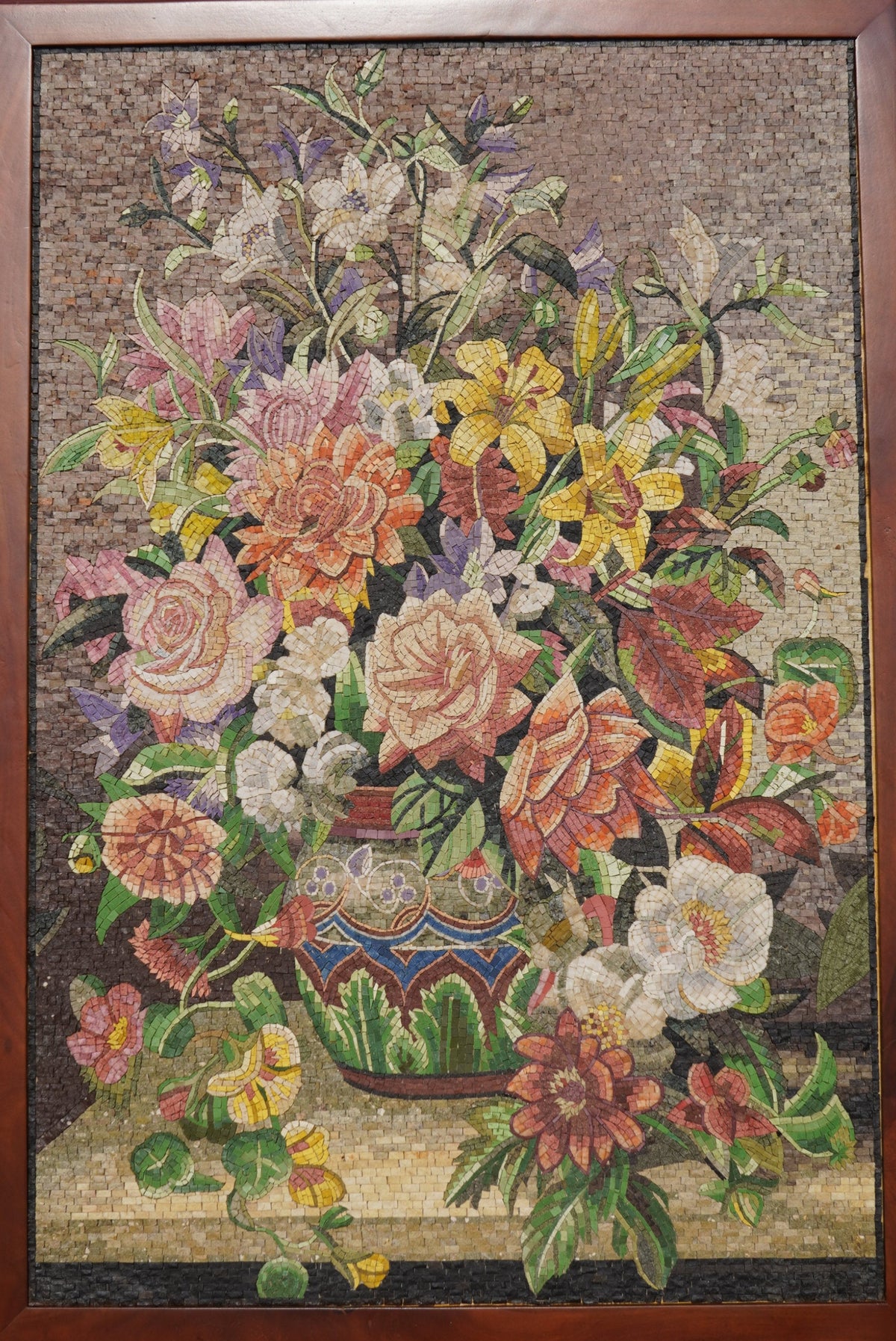 Vibrant floral mosaic artwork featuring a colorful arrangement of roses and lilies in an ornate vase on a textured background