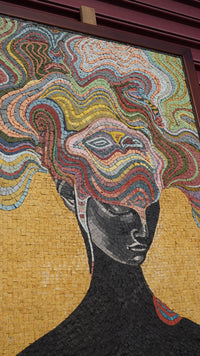 Intricate mosaic art featuring a black silhouette with colorful, swirling patterns — a striking blend of texture and design.