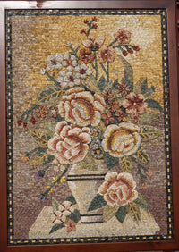 Intricate floral mosaic artwork featuring a vase filled with roses and blossoms in warm earth tones — a textured and vibrant display.
