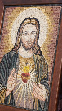 Intricate mosaic artwork depicting a figure with long hair and a sacred heart — vibrant colors and detailed craftsmanship