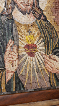 Intricate mosaic artwork depicting a heart surrounded by rays of light — detailed craftsmanship in vibrant, earthy tones.