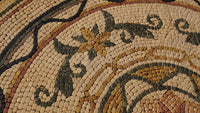 Intricate mosaic tile design featuring earthy tones and floral patterns — a blend of natural stone textures.