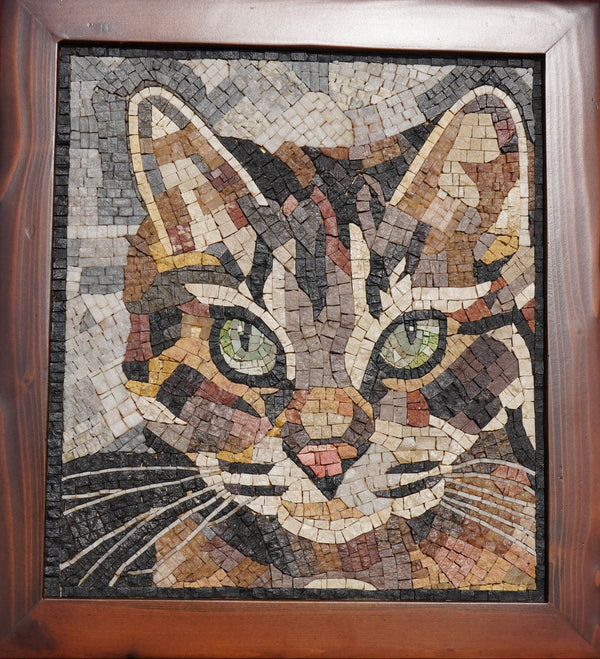 Intricate mosaic art piece depicting a cat's face with green eyes, crafted from various textured stones and earthy tones.