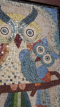Colorful mosaic artwork featuring two owls in intricate detail — vibrant tiles create a charming and whimsical design.