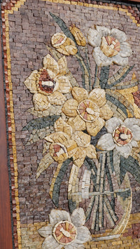Intricate floral mosaic artwork featuring yellow and white flowers set against a textured brown background — a stunning display of craftsmanship.